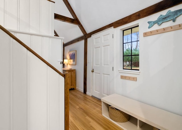 mudroom featuring light wood-type flooring and lofted ceiling with beams