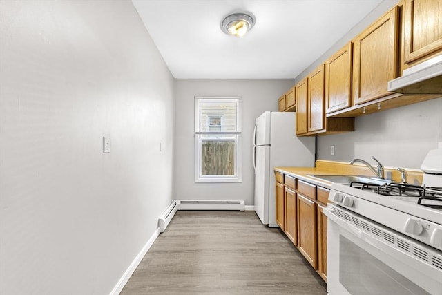 kitchen featuring a baseboard heating unit, sink, white appliances, and light hardwood / wood-style floors