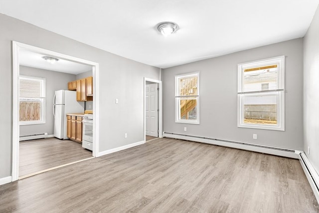 unfurnished living room with light wood-type flooring and baseboard heating