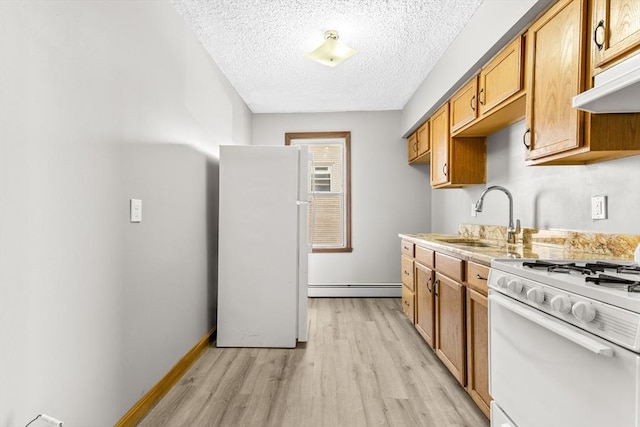 kitchen featuring white appliances, baseboard heating, a textured ceiling, light hardwood / wood-style flooring, and sink