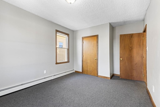 unfurnished bedroom featuring carpet floors, a baseboard heating unit, and a textured ceiling