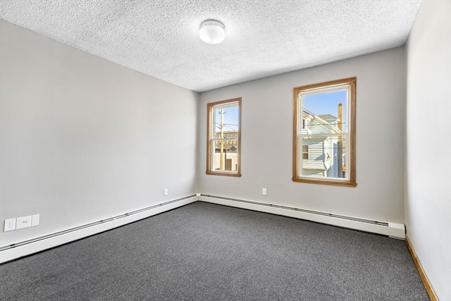 empty room with carpet floors, baseboard heating, and a textured ceiling