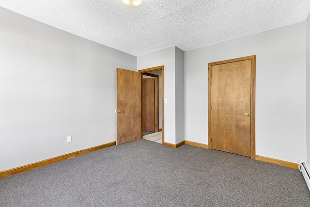 unfurnished bedroom featuring a textured ceiling, baseboard heating, and carpet floors