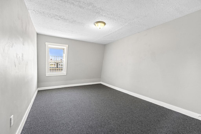 unfurnished room with a textured ceiling