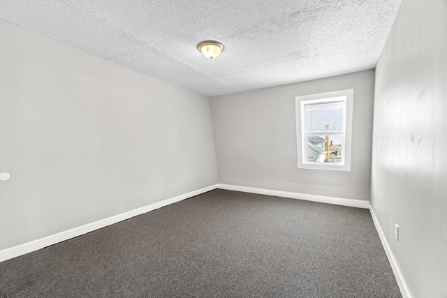 unfurnished room featuring a textured ceiling and carpet flooring