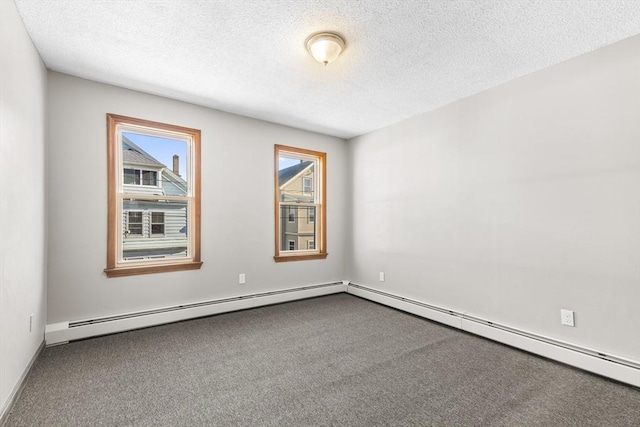 carpeted empty room with baseboard heating and a textured ceiling