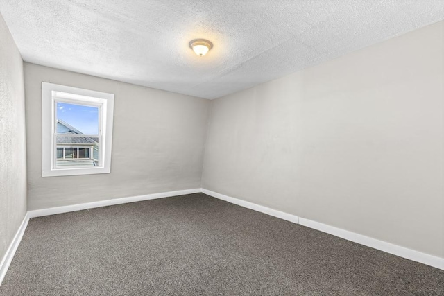 carpeted spare room featuring a textured ceiling