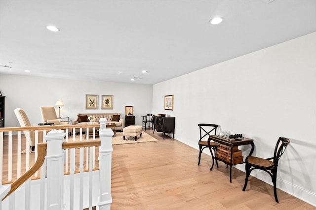 sitting room with light wood-style floors, recessed lighting, and baseboards