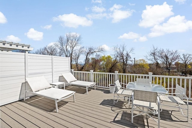 wooden deck featuring outdoor dining area