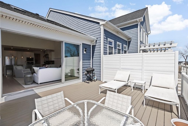 wooden terrace featuring outdoor dining area