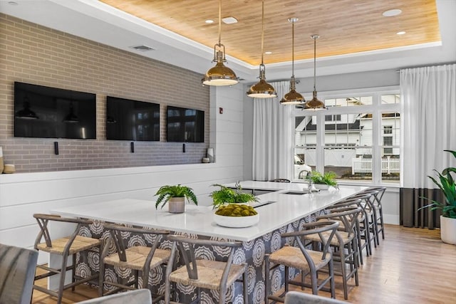 dining room featuring recessed lighting, wood ceiling, wood finished floors, and a tray ceiling