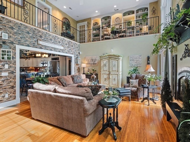 101 Colonial Dr Unit 101, Sturbridge, MA 01566 - living room featuring a high ceiling, wood finished floors, and recessed lighting
