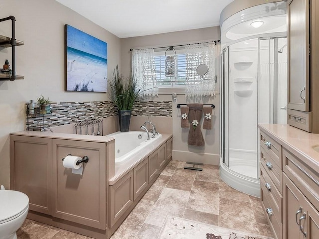 101 Colonial Dr Unit 101, Sturbridge, MA 01566 - bathroom featuring a shower stall, a bath, toilet, stone finish flooring, and vanity