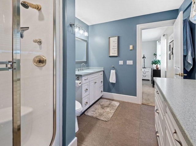 101 Colonial Dr Unit 101, Sturbridge, MA 01566 - full bath with vanity, a shower stall, tile patterned floors, toilet, and baseboards