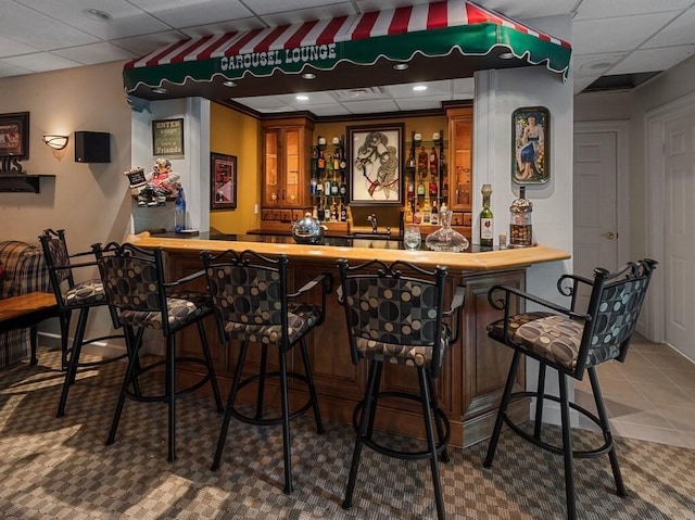 101 Colonial Dr Unit 101, Sturbridge, MA 01566 - indoor wet bar with a paneled ceiling and tile patterned flooring