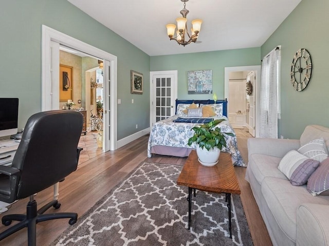 101 Colonial Dr Unit 101, Sturbridge, MA 01566 - bedroom featuring wood finished floors, a desk, a chandelier, baseboards, and ensuite bathroom