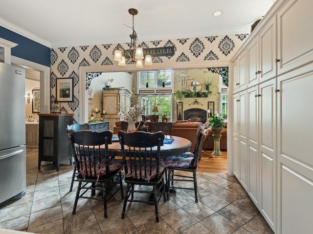 101 Colonial Dr Unit 101, Sturbridge, MA 01566 - dining room featuring crown molding, a chandelier, wallpapered walls, and a fireplace