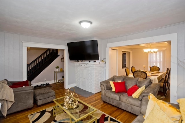 living room with a chandelier and dark hardwood / wood-style floors