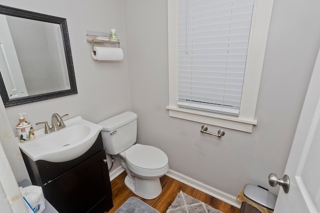 bathroom featuring hardwood / wood-style floors, vanity, and toilet