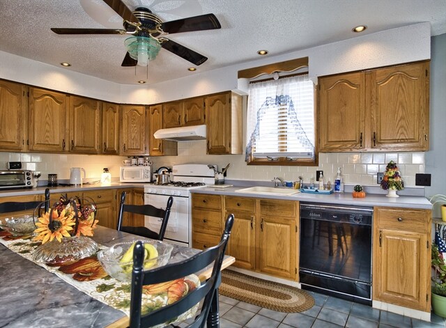 kitchen with white appliances, sink, a textured ceiling, ceiling fan, and tile patterned floors