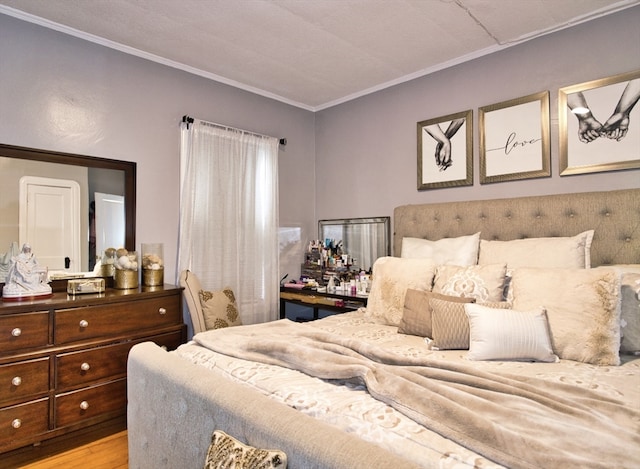 bedroom featuring light hardwood / wood-style floors and crown molding