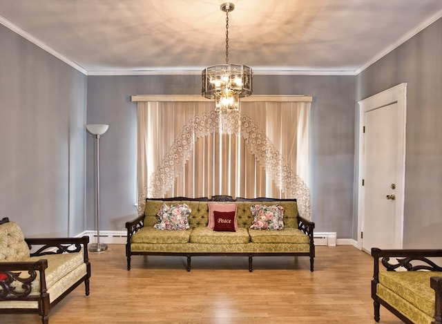 sitting room featuring hardwood / wood-style flooring, ornamental molding, an inviting chandelier, and baseboard heating