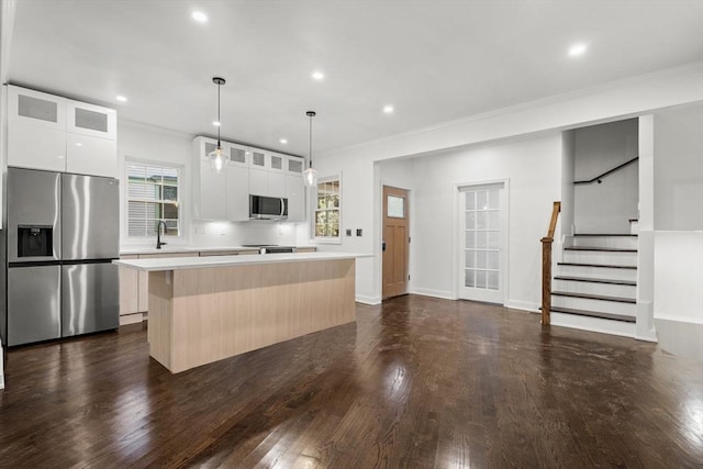 21 Greystone Rd Unit 2, Malden, MA 02148 - kitchen featuring stainless steel appliances, a center island, plenty of natural light, light countertops, and crown molding