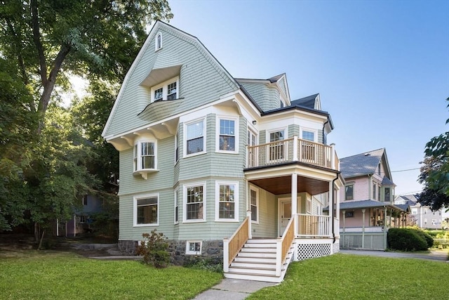 21 Greystone Rd Unit 2, Malden, MA 02148 - view of front of property with a balcony, a front yard, and a gambrel roof