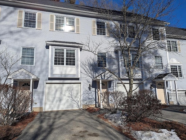 multi unit property featuring a garage and driveway