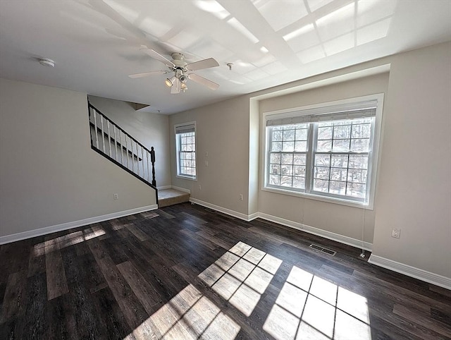 interior space featuring stairs, dark wood-type flooring, and baseboards