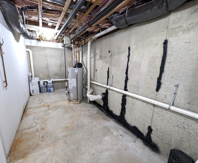 unfinished basement featuring water heater