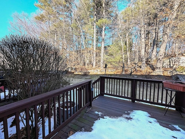 wooden terrace with a wooded view