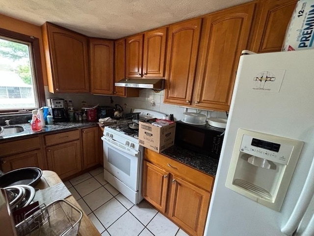 10 Gloversbrook Rd, Randolph, MA 02368 - kitchen featuring white appliances, under cabinet range hood, brown cabinetry, a textured ceiling, and light tile patterned flooring
