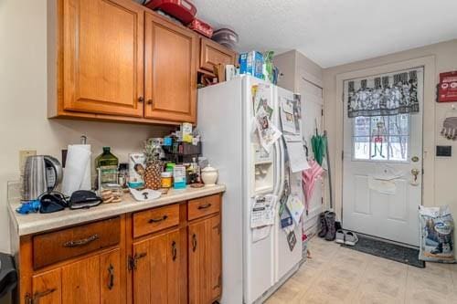 kitchen featuring white fridge with ice dispenser