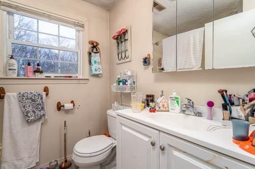 bathroom featuring vanity and toilet