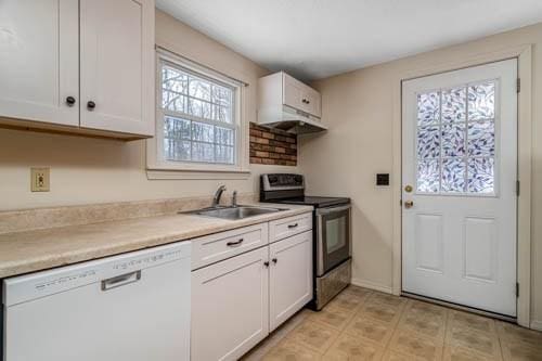 kitchen with stainless steel electric range oven, white dishwasher, sink, and white cabinets