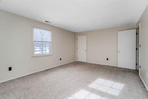 unfurnished room with light carpet