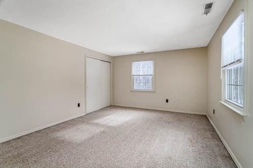 spare room with light colored carpet