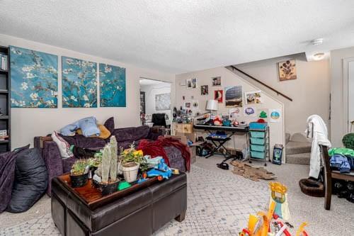 carpeted living room with a textured ceiling