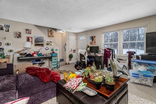 carpeted living room featuring a textured ceiling