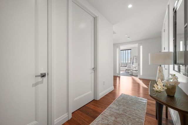 corridor featuring dark hardwood / wood-style flooring