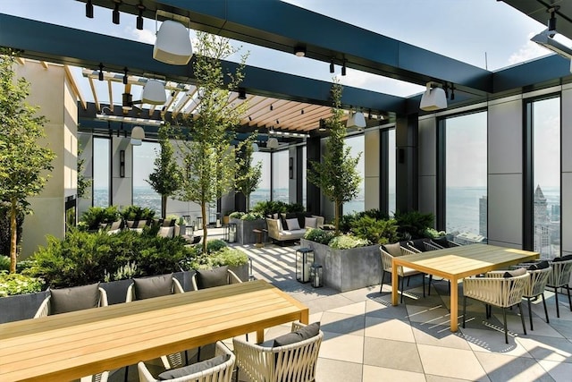 view of patio with a pergola and a water view