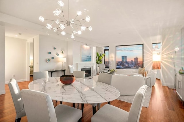 dining area featuring an inviting chandelier and light hardwood / wood-style flooring