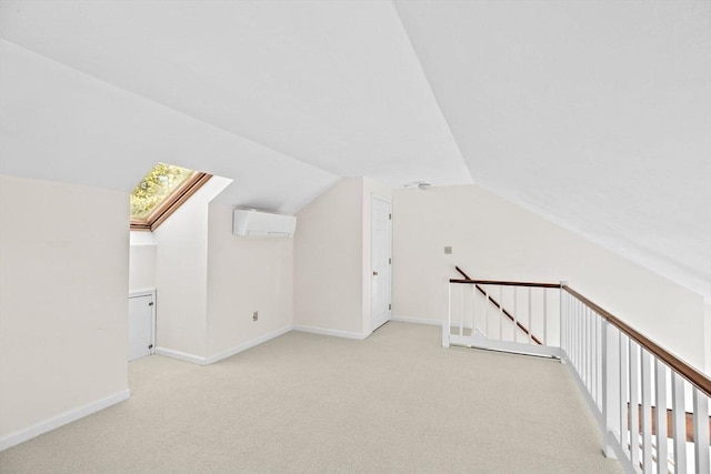 bonus room featuring vaulted ceiling with skylight, light carpet, and a wall mounted air conditioner