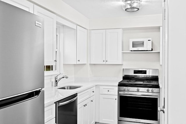 kitchen with sink, stainless steel appliances, and white cabinetry