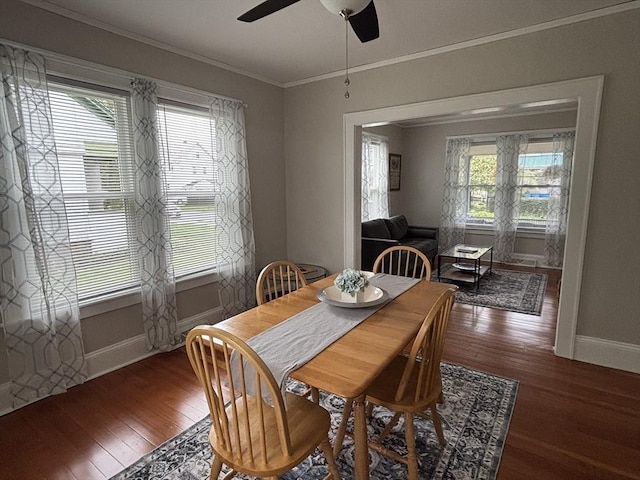 dining room with wood finished floors, baseboards, and ornamental molding