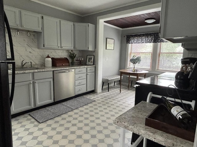 kitchen with freestanding refrigerator, light floors, stainless steel dishwasher, a sink, and crown molding