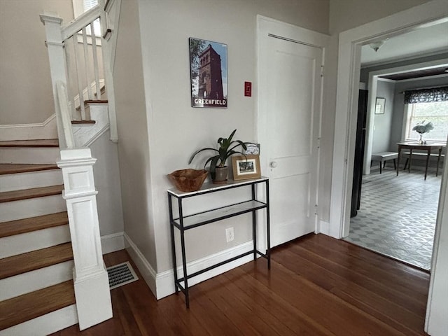 interior space with baseboards and wood finished floors
