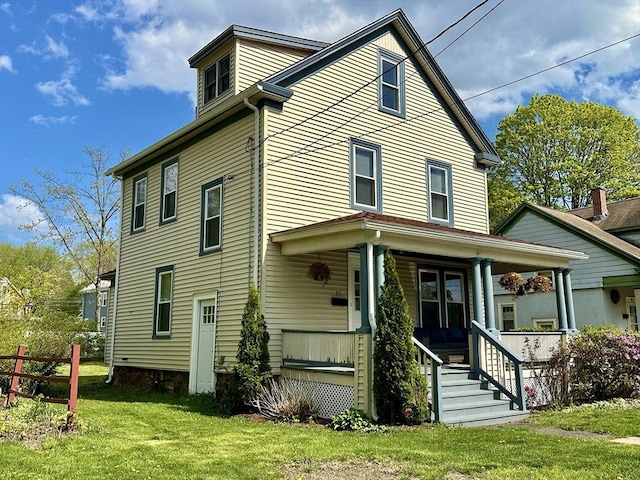 view of front of home with a porch and a front lawn