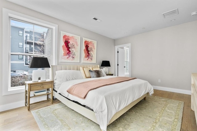 220 Bowen St Unit 2, Boston, MA 02127 - bedroom featuring multiple windows, light wood-style floors, and baseboards